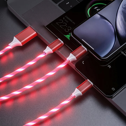 Four Zainzio red LED streamer charging cables glow brightly, connecting to a laptop and smartphones. The laptop screen displays.