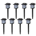 Set of eight solar-powered garden lights on black stakes with a white background
