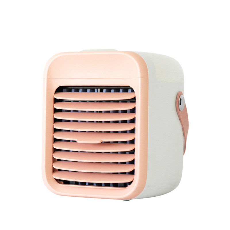 A compact, portable Zainzio misting cooler in cream with a peach front grille and handle. This rechargeable water cooling fan is shown.