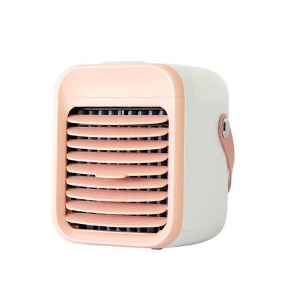 A compact, portable Zainzio misting cooler in cream with a peach front grille and handle. This rechargeable water cooling fan is shown.