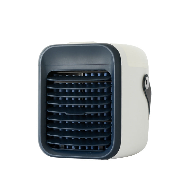A small, two-tone portable air cooler is shown. It features an off-white body with a dark blue front grille and a small black carrying strap on the side.