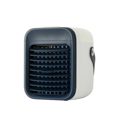 A small, two-tone portable air cooler is shown. It features an off-white body with a dark blue front grille and a small black carrying strap on the side.