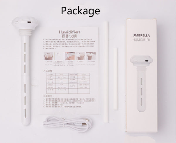 The humidifier's package contents are shown: the white stick humidifier, USB cable, filter sticks, instruction manual titled "Humidifiers" and "操作说明", and its box labeled "UMBRELLA HUMIDIFIER".