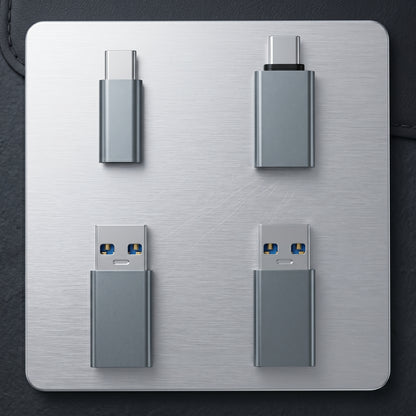 Four gray USB data shielding adapters are displayed on a metallic surface. They include two USB-C to USB-C and two USB-A to USB-C types.