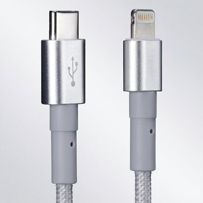 Close-up of a silver braided cable showing a USB-C connector on the left with a USB symbol, and a Lightning connector on the right.