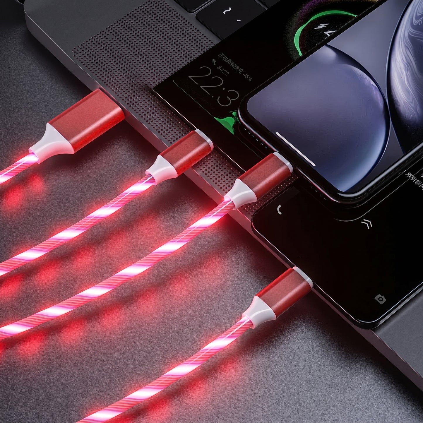 Four Zainzio red LED streamer charging cables glow brightly, connecting to a laptop and smartphones. The laptop screen displays.
