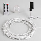 White LED string lights coiled in a large circle, shown with a silver remote control, a roll of clear adhesive tape, and a black power adapter on a light gray background.