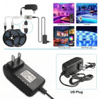 This image features Zainzio RGB LED strip light components: two rolls, power adapter (AC ADAPTOR, US Plug), and controller. It highlights features like IR remote, phone app, and white light control.