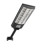 A black solar street light, angled up, displays its many LED panels and mounting bracket. The label reads: "SOLAR STREET LIGHT 8000W".