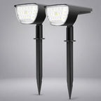 Two black solar-powered stake-mounted LED garden lights shown side by side against a neutral gray background.