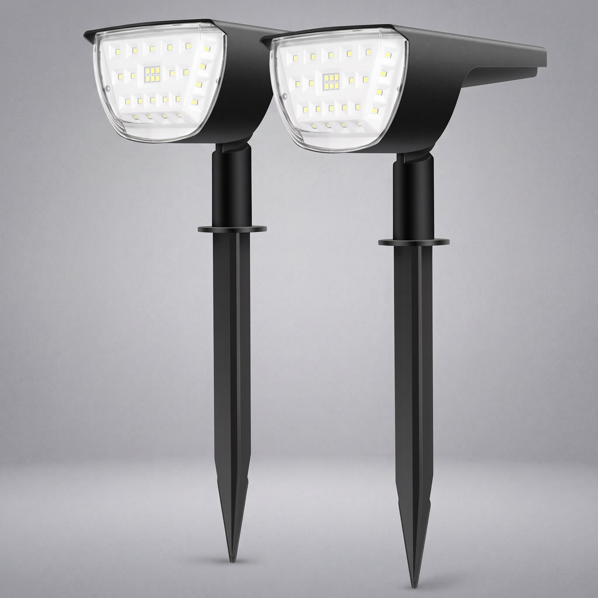 Two black solar-powered stake-mounted LED garden lights shown side by side against a neutral gray background.