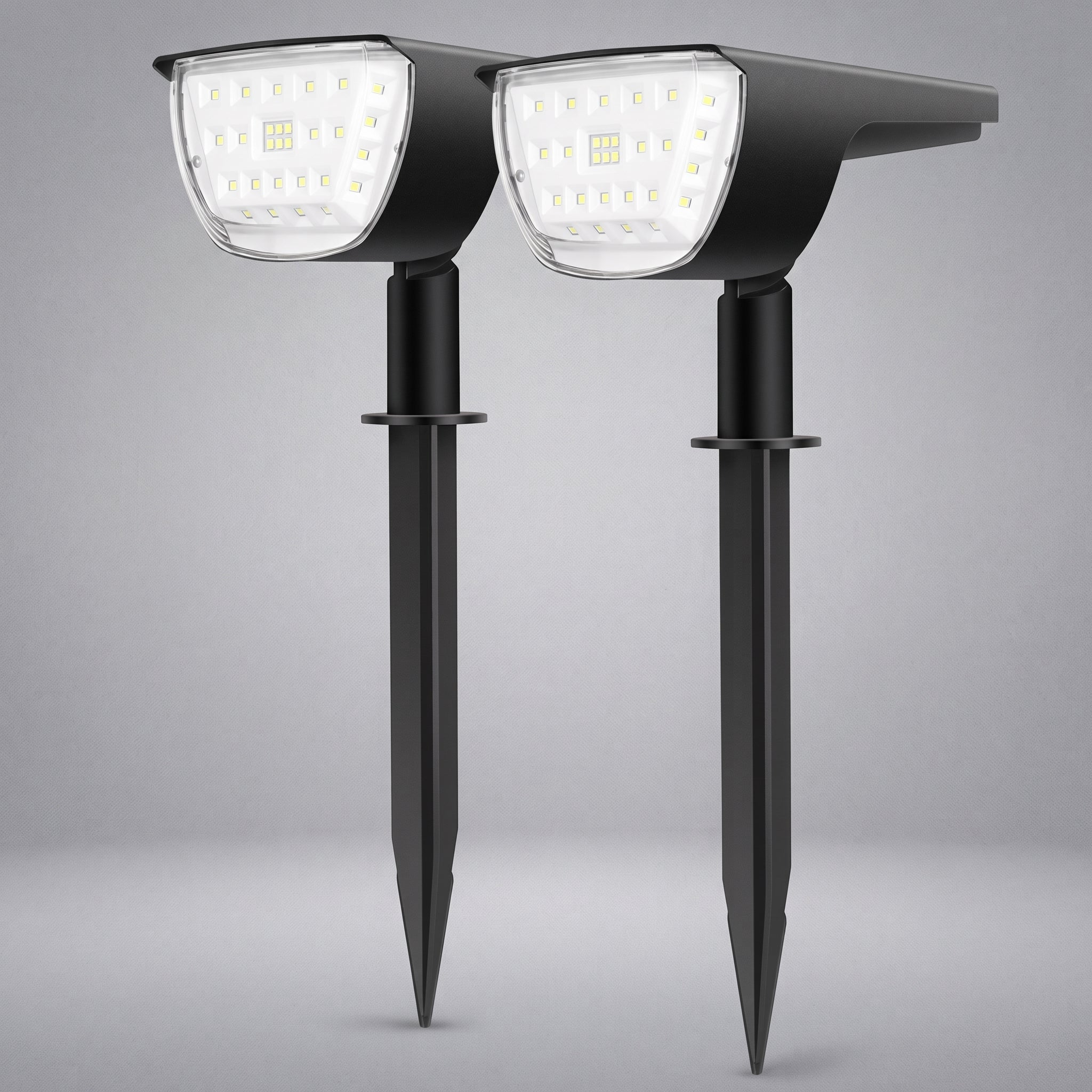 Two black solar-powered stake-mounted LED garden lights shown side by side against a neutral gray background.