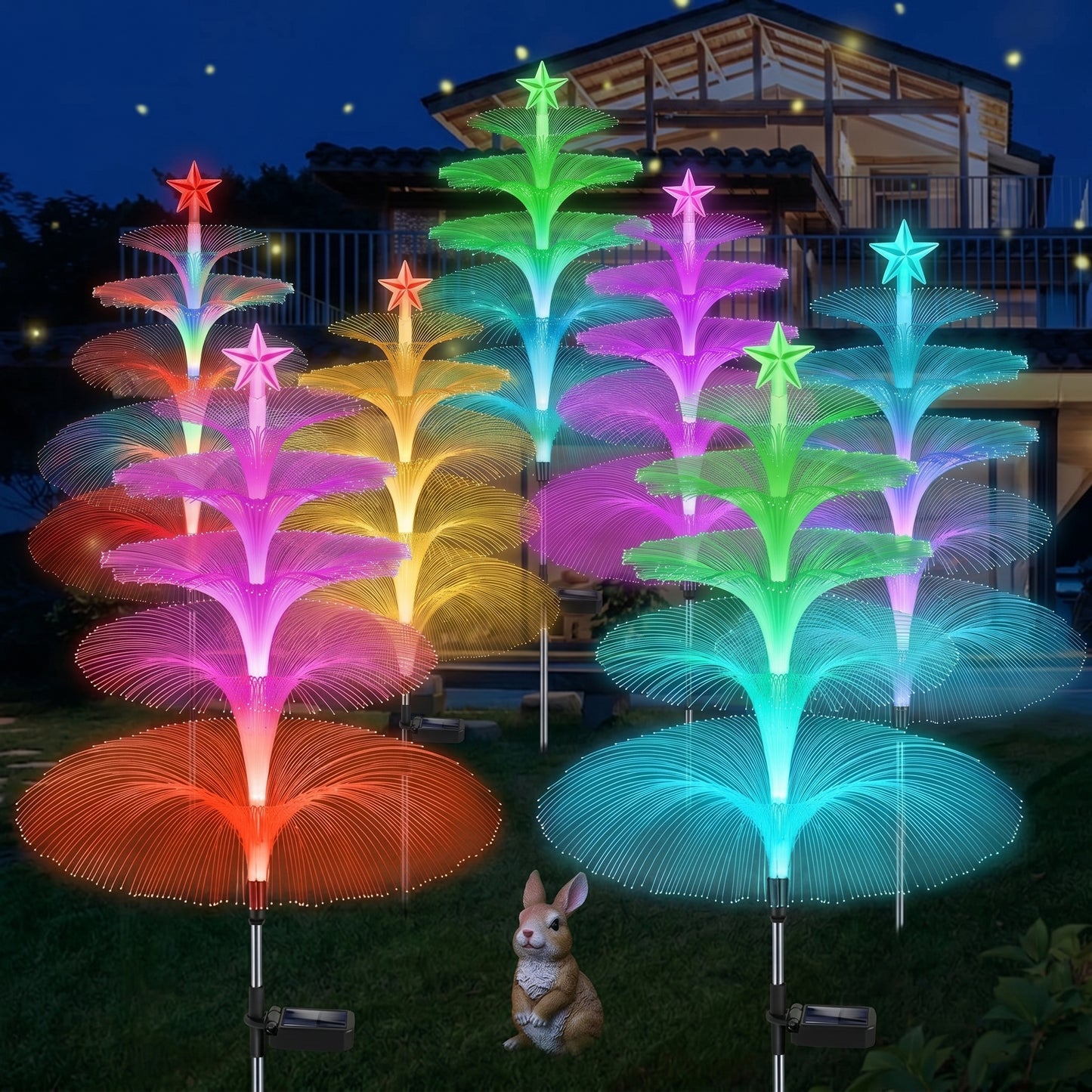 Colorful LED tree lights in a garden setting with a small rabbit figurine. Zainzio 8 Pack Solar Jellyfish Garden Lights, Color-Changing Fiber Optic Stakes.