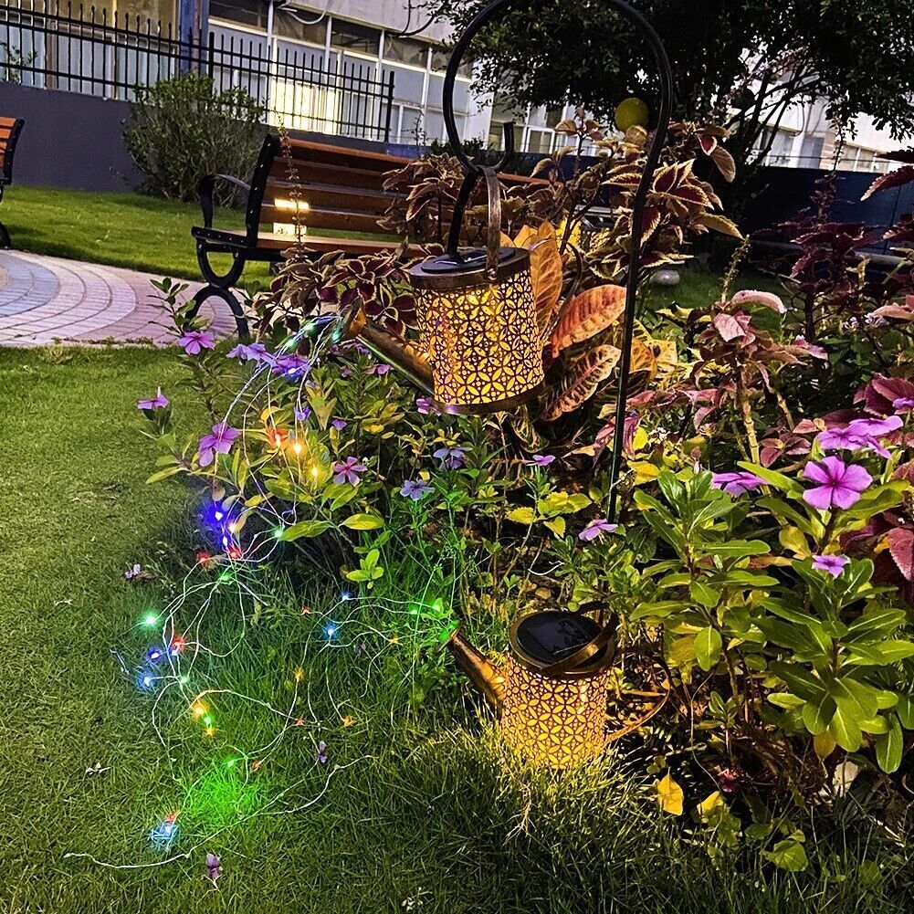 Decorative garden with solar lights and teapots on grass
