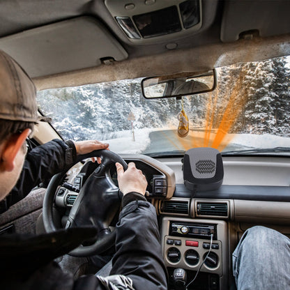 A driver's view from inside a car with a portable heater on the dashboard emitting orange heat, driving on a snowy road.