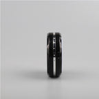 A black Zainzio puck light is shown from its side. It features a silver accent band and a small port.