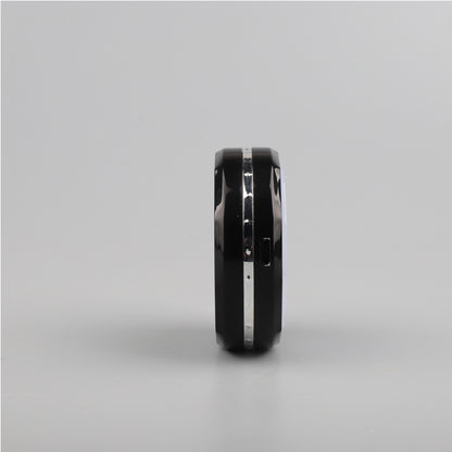 A black Zainzio puck light is shown from its side. It features a silver accent band and a small port.