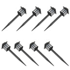 Set of eight black solar-powered outdoor lights on a white background