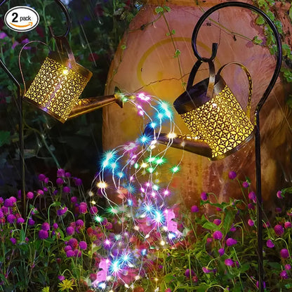 Solar string lights in front of a decorative watering can with flowers in the background