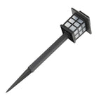 Solar-powered outdoor light with a black stake on a white background