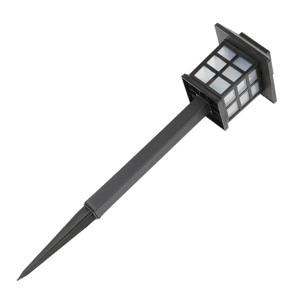 Solar-powered outdoor light with a black stake on a white background