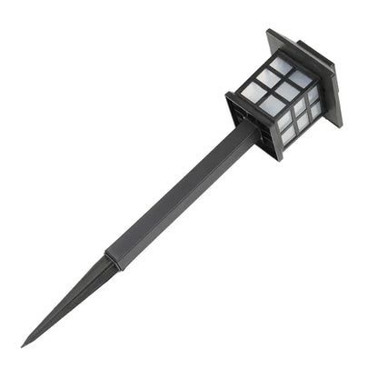 Solar-powered outdoor light with a black stake on a white background