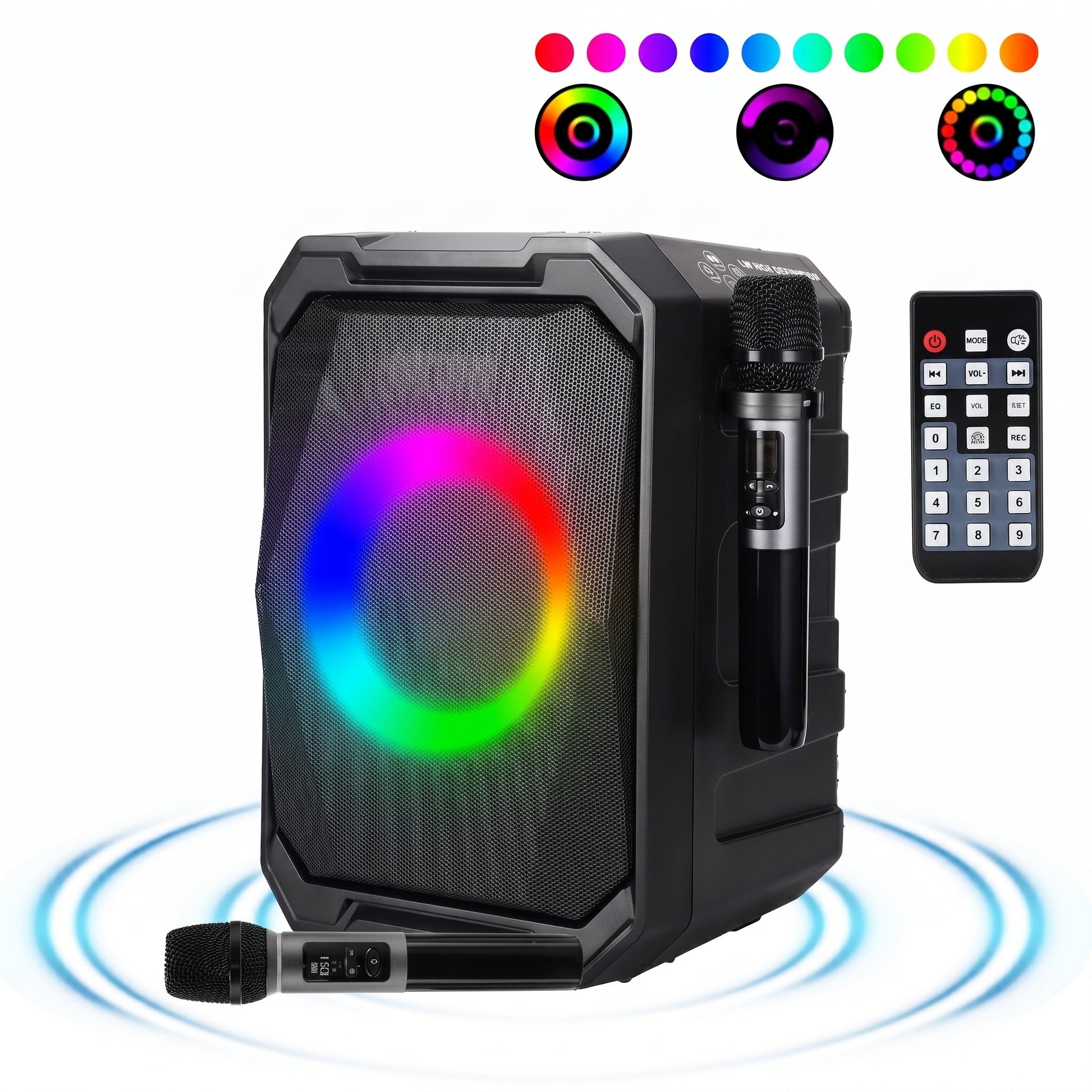 A black portable party speaker displays a vibrant rainbow RGB light ring on its grille, presented with two microphones and a remote control.