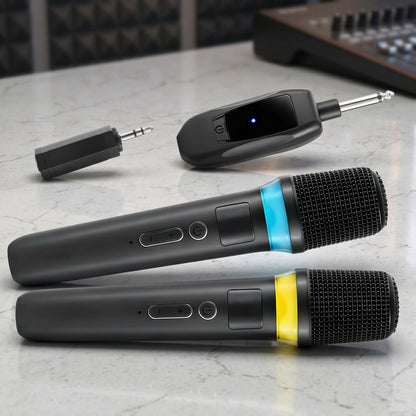 A Zainzio dual wireless microphone system is shown, including two black microphones with blue and yellow indicator bands, plus a receiver and adapters. They rest on a light-colored surface.