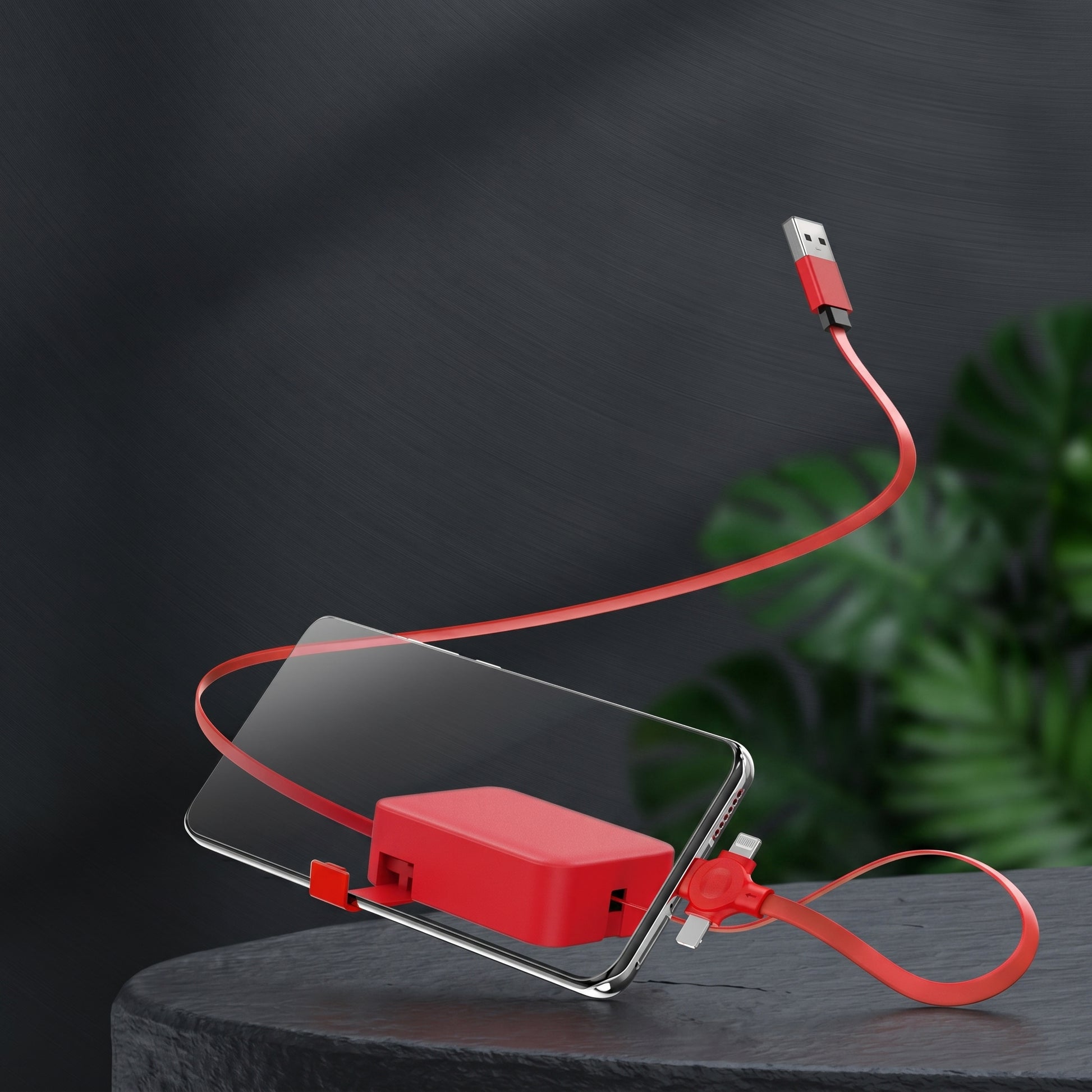 A red Zainzio 4-in-1 retractable cable is displayed, extending from a compact red housing to connect to a clear phone stand. The cable's USB-A end is also visible, all set against a dark, minimalist background.