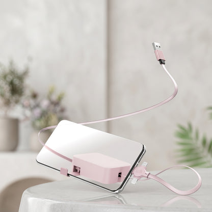 A pink Zainzio 4-in-1 retractable cable is attached to a smartphone, with its USB end floating above. This product image highlights the cable's compact design.