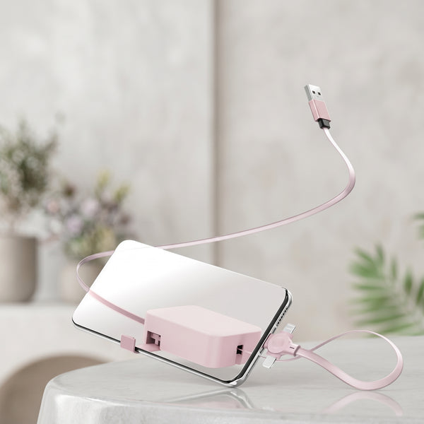A pink Zainzio 4-in-1 retractable cable is attached to a smartphone, with its USB end floating above. This product image highlights the cable's compact design.