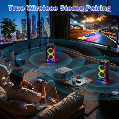 A couple relaxes in a modern living room, enjoying a TV and two colorful RGB-lit speakers demonstrating "True Wireless Stereo Pairing.