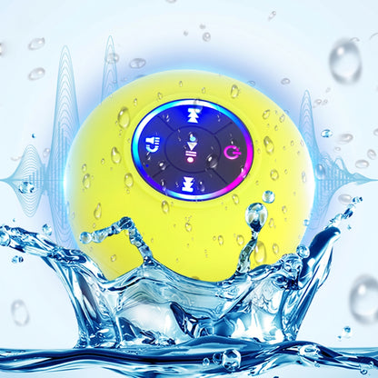 A bright yellow waterproof Bluetooth speaker with illuminated controls splashes dramatically in water, set against a background of blue sound waves.