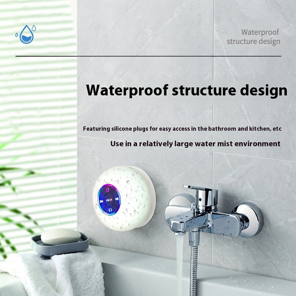 A white, round Bluetooth speaker with colorful LED lights, shown wet and mounted in a bathroom next to a faucet. Text: "Waterproof structure design.