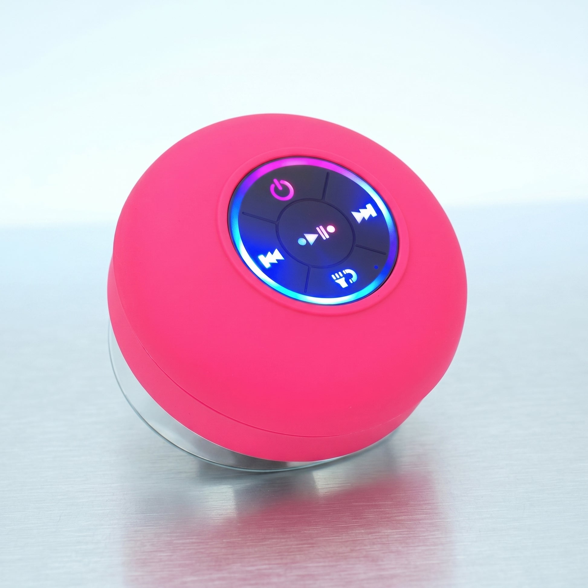 A vibrant pink waterproof Bluetooth speaker is shown, featuring illuminated control buttons and a visible suction cup base.