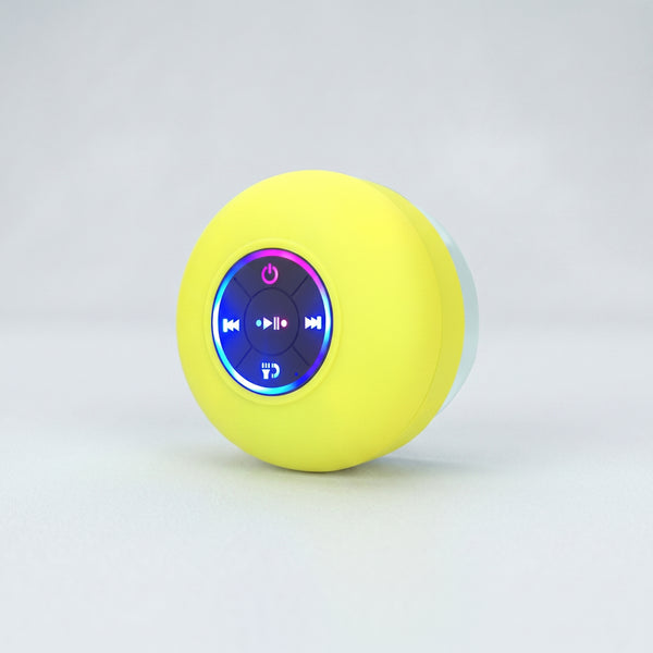 A bright yellow Zainzio BTS07 waterproof Bluetooth speaker is shown. Its front features illuminated blue and purple control buttons for power, media playback, and calls.