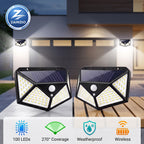 Two black solar-powered outdoor security light fixtures shown on a wooden deck in front of a house, with beams of light projecting outward. The image includes a ZAINZIO brand logo in the top-left corner and feature icons at the bottom highlighting 100 LEDs, 270-degree coverage, weatherproof design, and wireless operation.