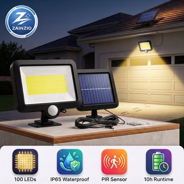 Two Zainzio solar motion-activated outdoor floodlights displayed on a porch at dusk, with one light turned on casting a warm yellow beam toward the house. The image includes feature icons at the bottom and a Zainzio logo in the top left.