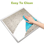 A square glass panel or mirror with a white frame, shown with a hand wiping it with a blue cloth. The text 'Easy To Clean' appears at the top on a white background.