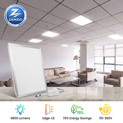 A large white LED office whiteboard with a silver frame is shown in the foreground, with a blurred office lounge room in the background. The image includes a ZAINZIO brand logo in the top-left corner and feature icons and text at the bottom highlighting 4800 lumens, edge-lit technology, energy savings, and voltage compatibility.