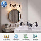 A wall-mounted three-light bathroom vanity fixture with clear glass shades and black metal arms, shown installed above a marble sink in a real bathroom setting. The image also includes a circular mirror, sconce, and feature icons at the bottom describing the product.