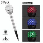 Solar garden stake lamp with a clear faceted ball top and black stake, shown on a white background with text reading '3 Pack,' 'RGB Mode,' 'Solar Energy,' and 'Waterproof IP 44.' Three inset images on the right show the ball lit in red, blue, and green.
