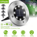 A pack of four round solar-powered outdoor landscape lights with brushed stainless steel housings, black ground stakes, and multiple built-in LED bulbs. The image includes a green lawn graphic showing light beams, text reading '4 Packs,' 'Solar Powered 19% Photoelectric Conversion Rate,' and feature icons for 'Auto On/Off,' 'IP65 Waterproof,' '8Hrs Runtime,' and 'Cost Saving.