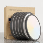 A set of round LED ceiling light panels with dark gray frames and white diffusers, shown leaning in front of their brown cardboard packaging box on a light gray background.