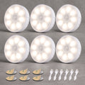 Six white round LED under-cabinet lights arranged in two rows on a gray background, with six adhesive pads and six USB charging cables shown below.
