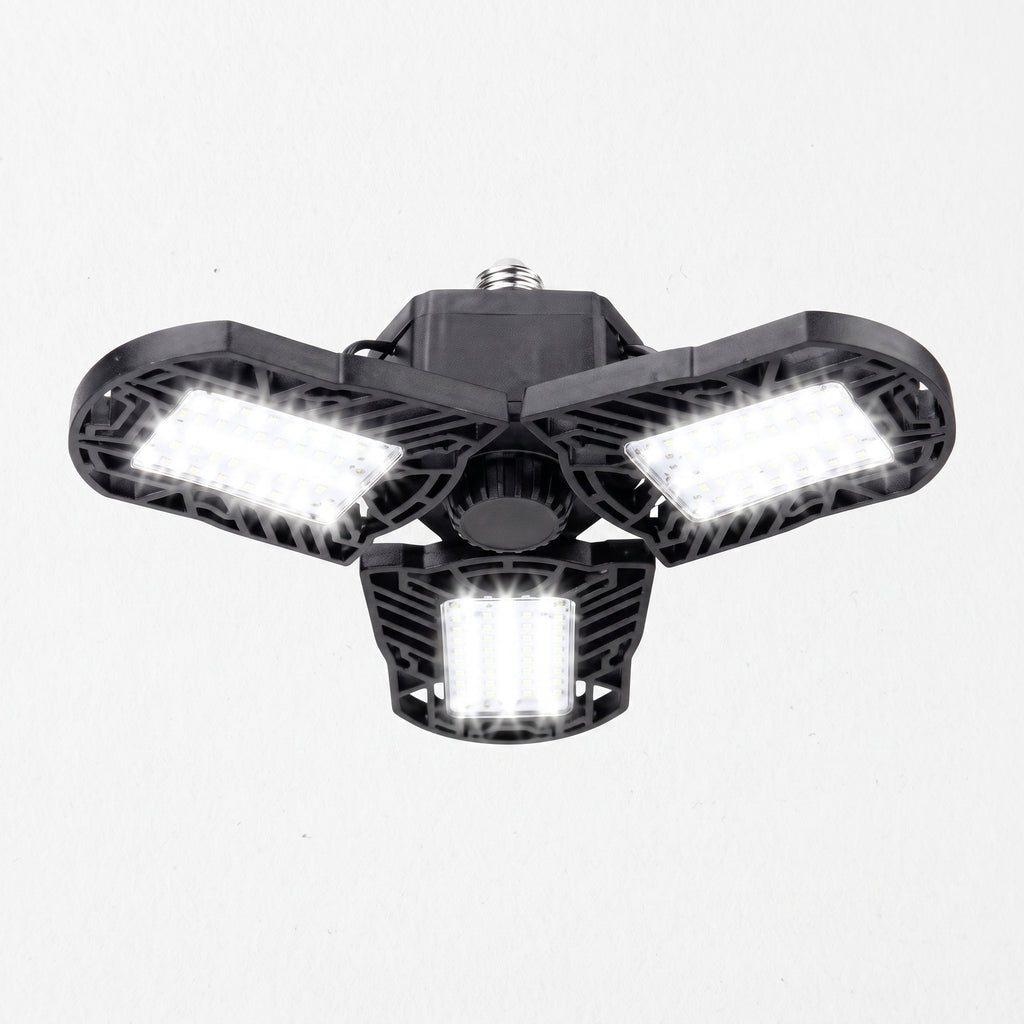 A three-light outdoor floodlight fixture with a black housing and bright white LED panels, shown against a plain white background.