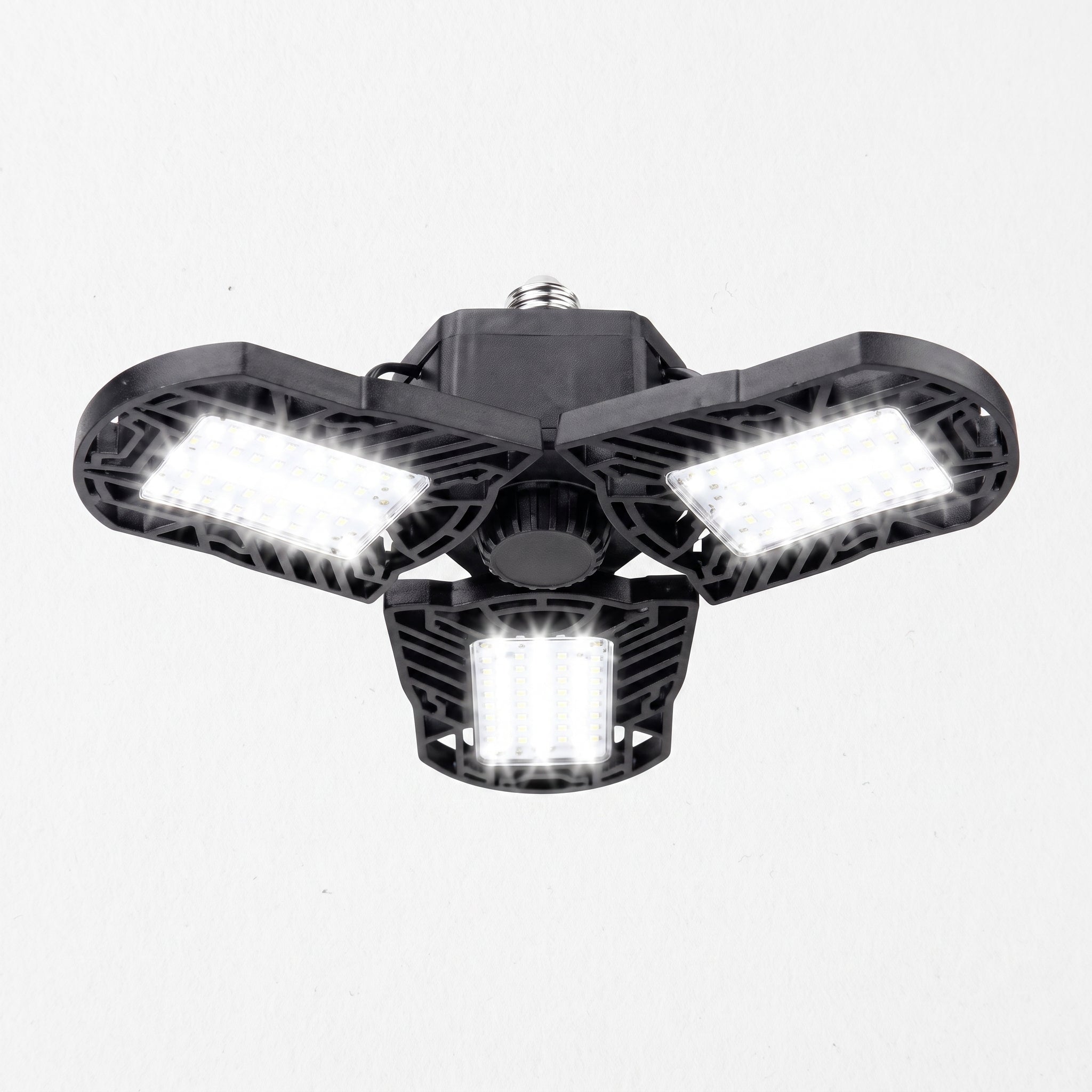 A three-light outdoor floodlight fixture with a black housing and bright white LED panels, shown against a plain white background.