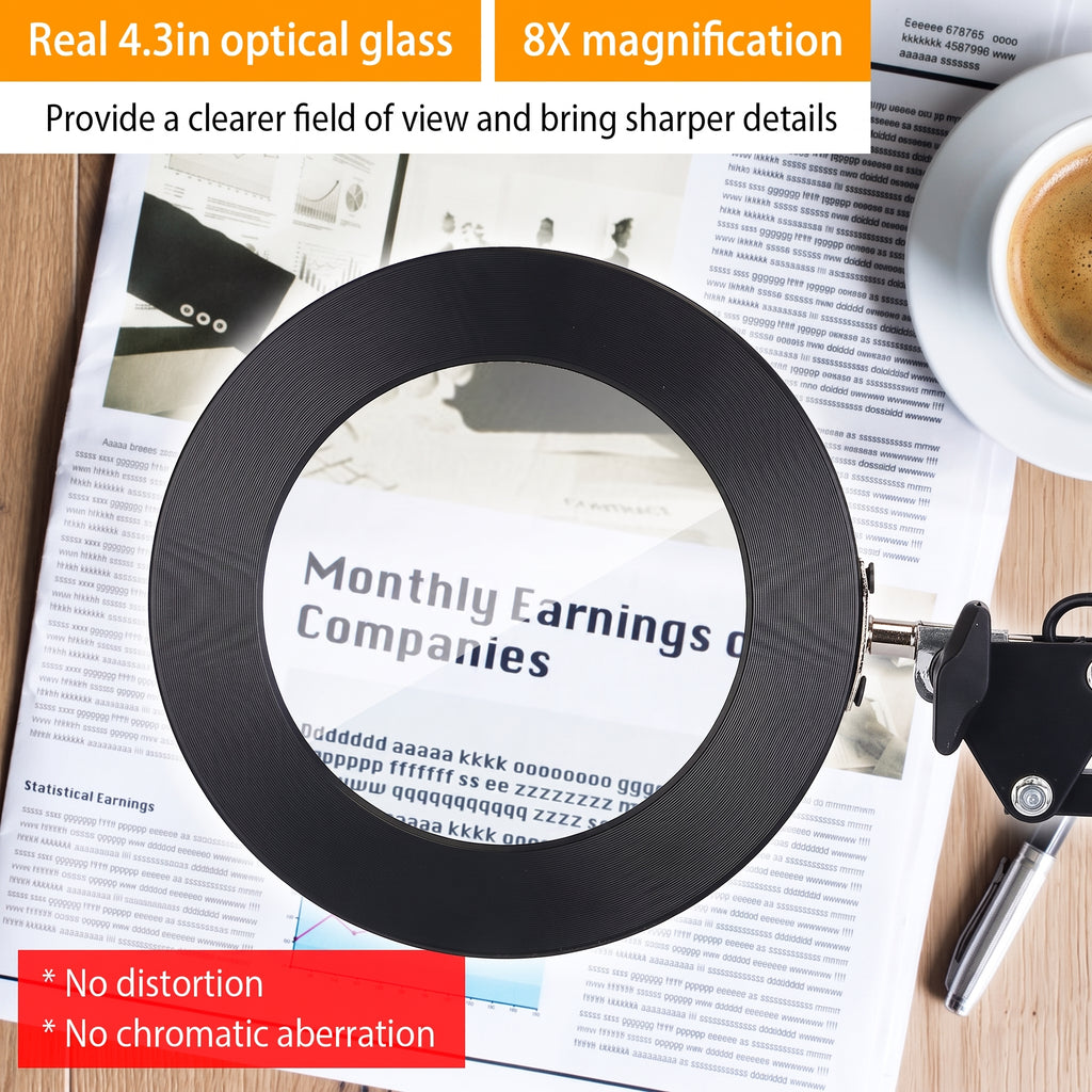 A black circular magnifying glass with a metal handle and key, shown on top of a newspaper with a coffee cup in the background. Text overlays highlight its features: 'Real 4.