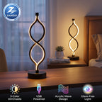 A modern Zainzio spiral LED table lamp with glowing acrylic sits on a wooden desk. It highlights "3-Color Dimmable," "USB Powered," "Acrylic Wave Design," and "Glare-Free Light" features.