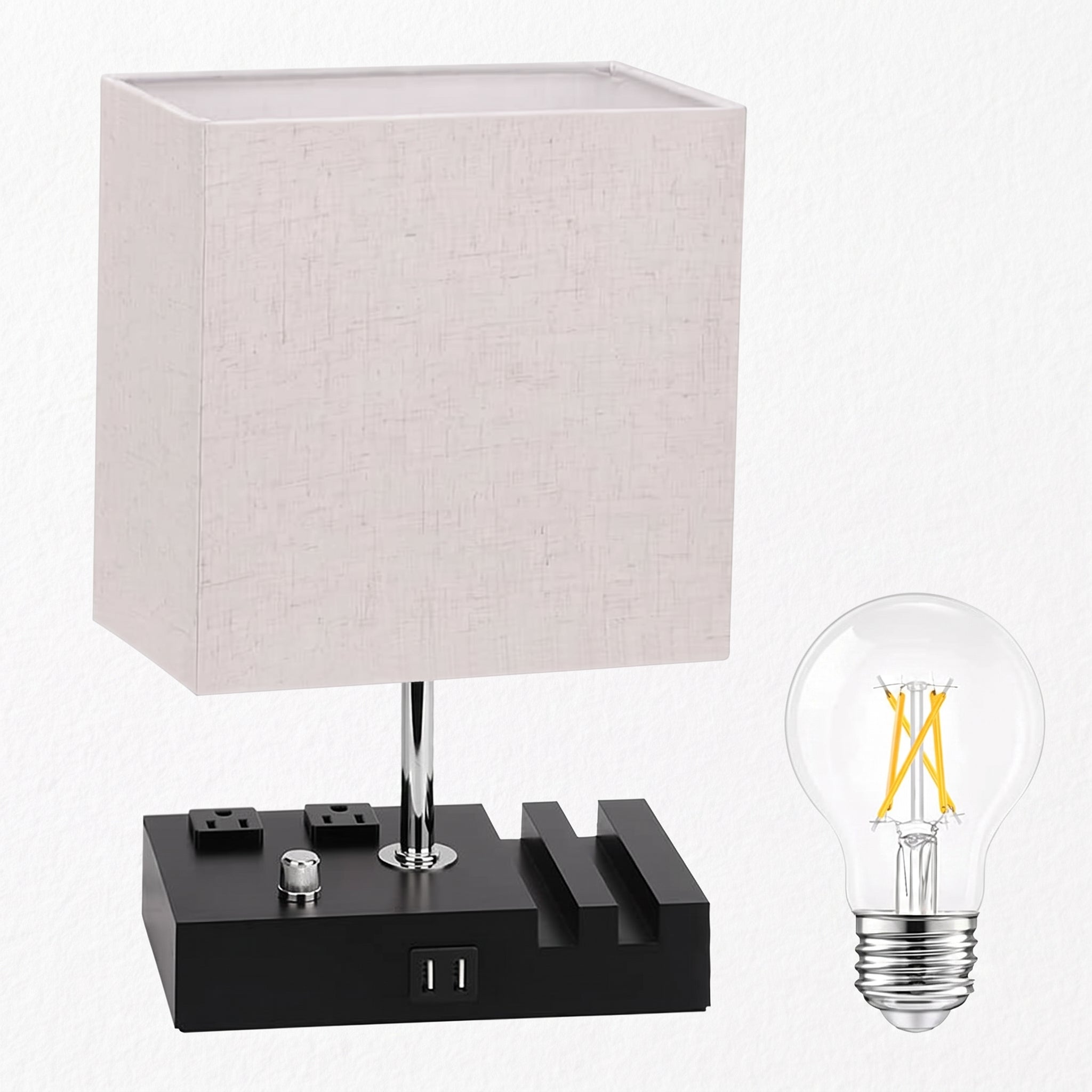 A modern table lamp with a square off-white linen shade, a black power bank-style base with built-in outlets, and a separate clear LED filament bulb shown beside it on a white background.